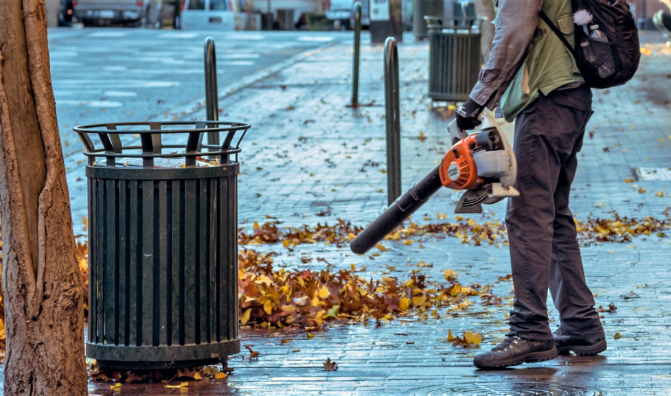 Person using gas powered leaf blower 