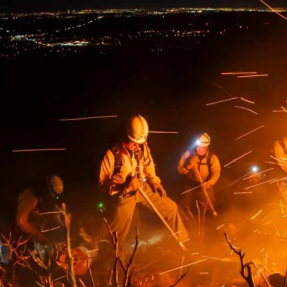 Picture of firefighters containing a wildfire above the City of Boulder