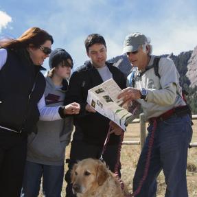 Volunteer Trail Guide, Rich Wolf, showing visitors a map